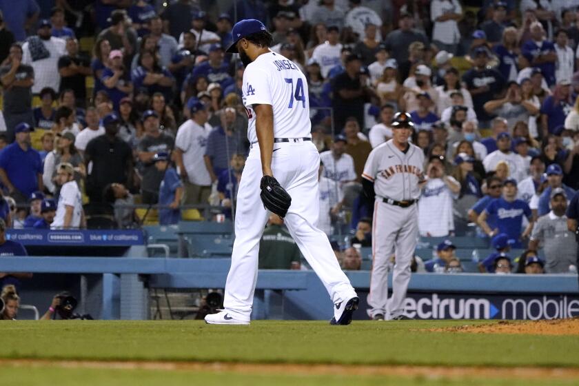 Dodgers pitcher Kenley Jansen walks off the field after being pulled in the ninth inning Thursday.