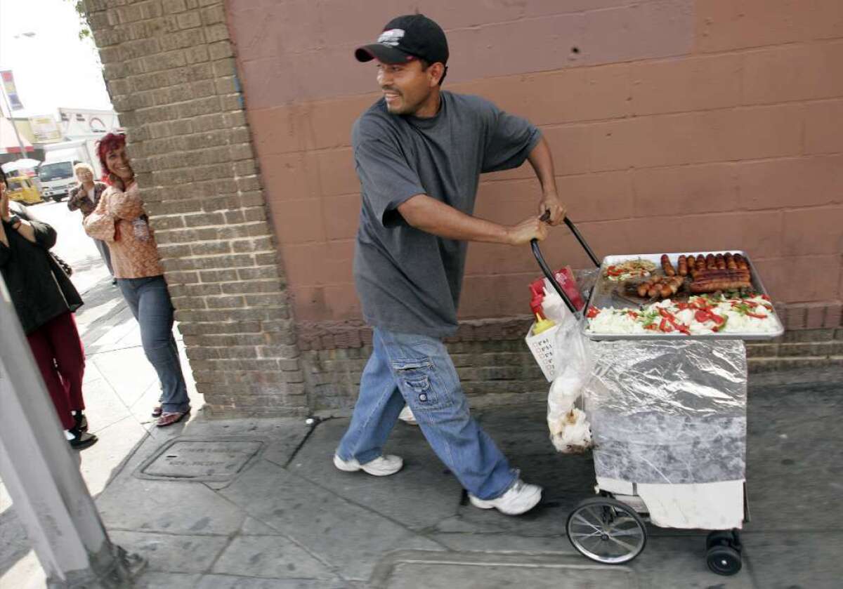Two L.A. City Council members are calling for a study of how the city can legalize street vending. Above, a file photo of a hot-dog vendor in downtown L.A.