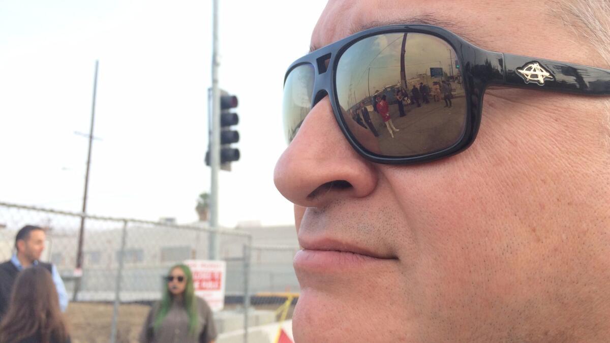 Artist Gerard Merz observes the shoot, reflected in his sunglasses.