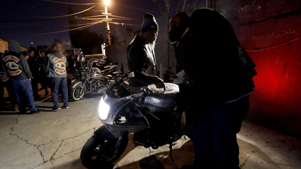 Members of the International Brotherhood of Street Racers hang out at the L.A. Deuces Motorcycle Club's clubhouse in South L.A. on Dec. 7, 2017.