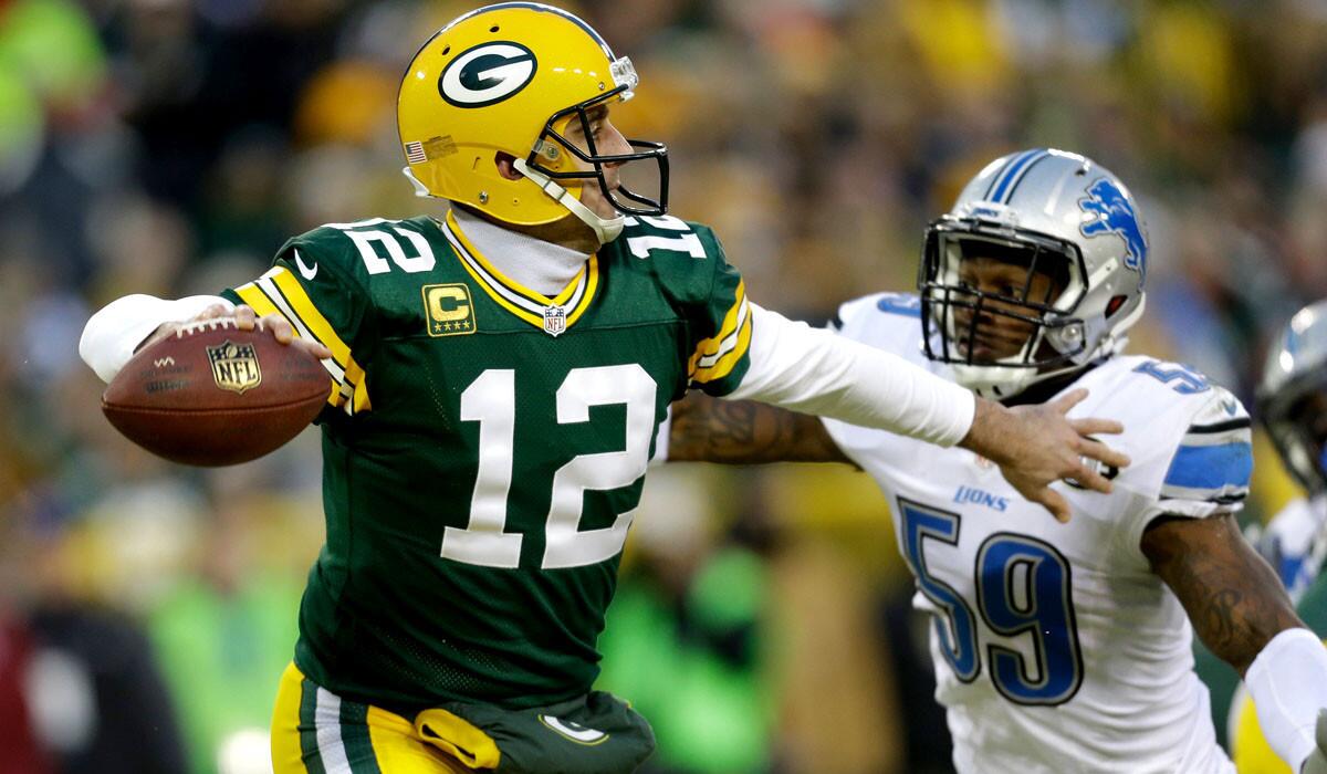 Packers quarterback Aaron Rodgers unloads a pass under pressure from Lions linebacker Tahir Whitehead in the second half Sunday.