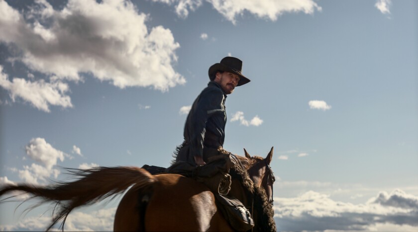 Benedict Cumberbatch rides a horse in a scene from "The Power of the Dog."