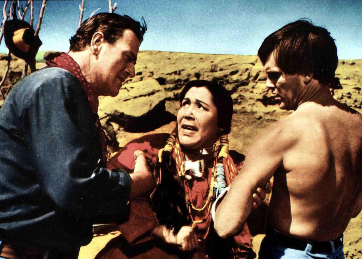 Ethan Edwards (John Wayne) and Martin Pawley (Jeffrey Hunter) confront a Native American woman (Beulah Archuletta) 