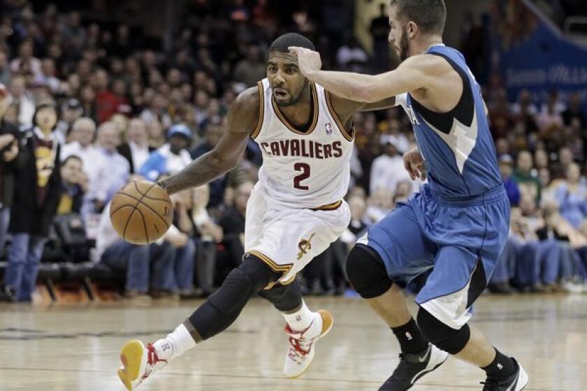 Cleveland's Kyrie Irving, left, drives past Minnesota's J.J. Barea during the Cavaliers' 93-92 win.