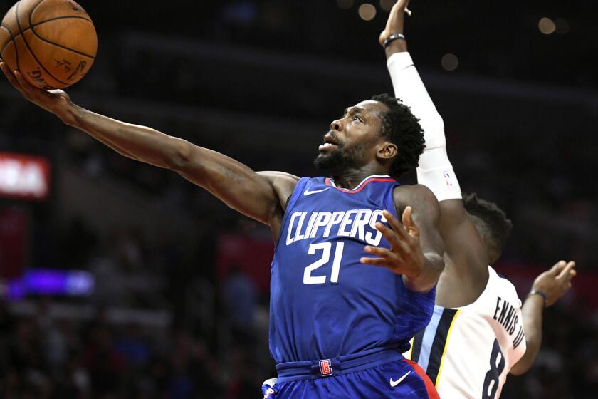 Los Angeles Clippers guard Patrick Beverley (21) shoots a layup against Memphis Grizzlies forward James Ennis III during an NBA basketball game, Saturday, Nov. 4, 2017, in Los Angeles. (AP Photo/Michael Owen Baker)