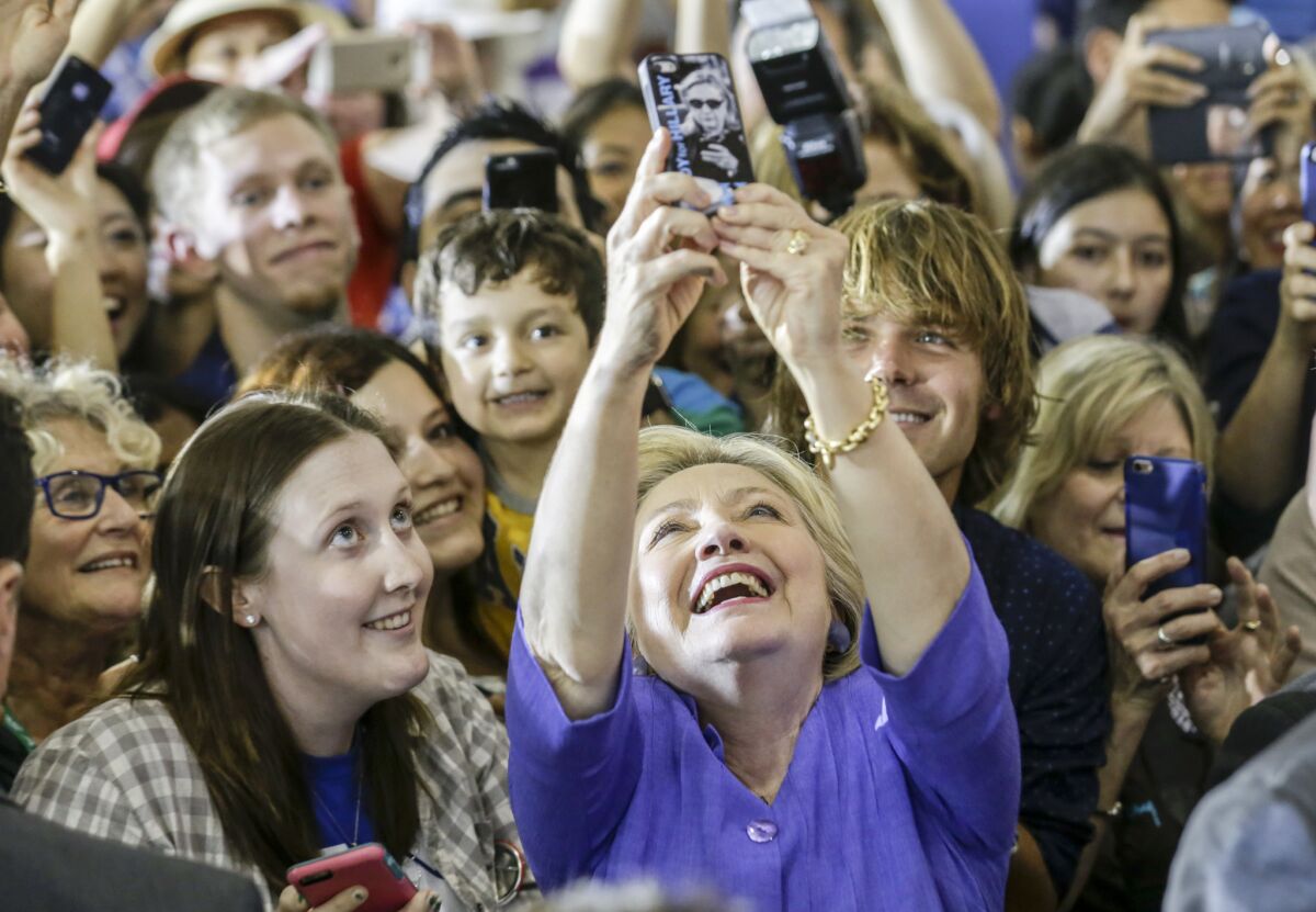 Hillary Clinton takes a selfie with her supporters after speaking at an event held at West Los Angeles College.