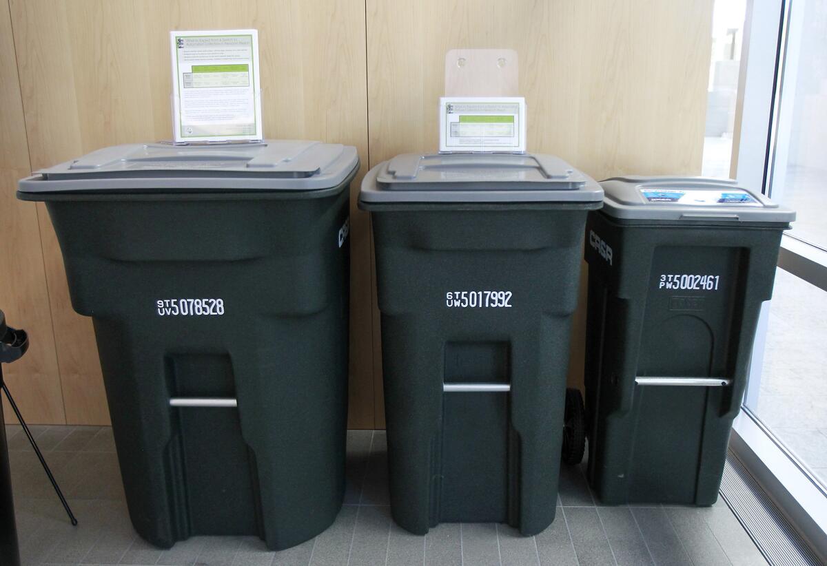 An example of wheeled trash receptacles on display at Newport Beach City Hall. These would be used in the automated trash pick-up service replacing manual service.