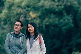 Two women on a hike smile.