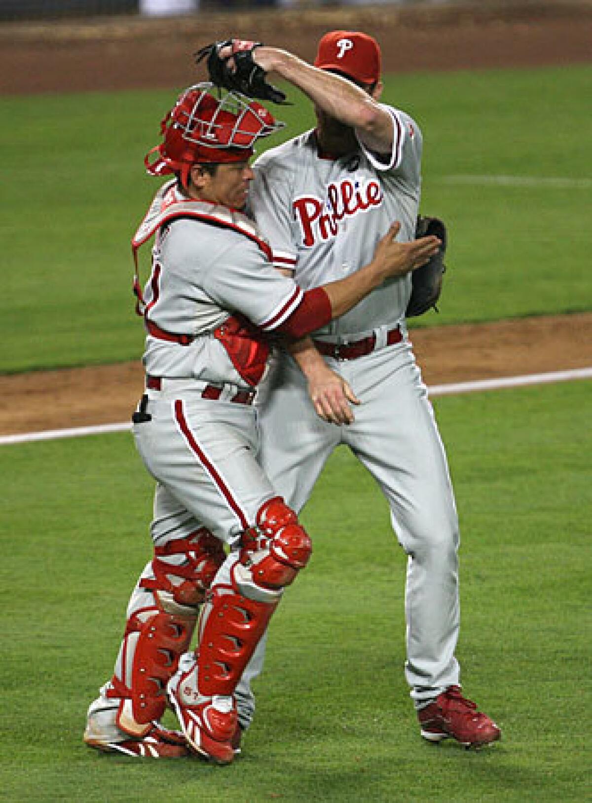 Phillies catcher Carlos Ruiz, who had a three-run home run in the fifth inning, and closer Brad Lidge congratulate each other after an 8-6 victory over the Dodgers in Game 1 of the National League Championship Series on Thursday night at Dodger Stadium.