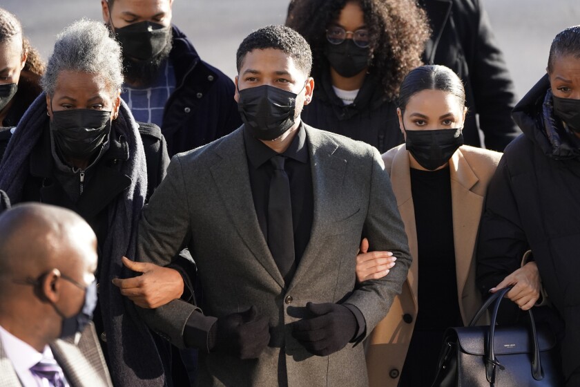 Actor Jussie Smollett, center, arrives Tuesday, Nov. 30, 2021, at the Leighton Criminal Courthouse for day two of his trial in Chicago. Smollett is accused of lying to police when he reported he was the victim of a racist, anti-gay attack in downtown Chicago nearly three years ago, in Chicago. (AP Photo/Charles Rex Arbogast)