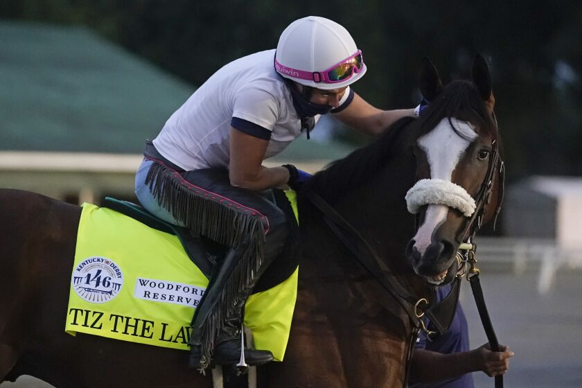 Exercise rider Heather Smullen takes Kentucky Derby entry Tiz the Law out for a workout at Churchill Downs, Wednesday, Sept. 2, 2020, in Louisville, Ky. (AP Photo/Darron Cummings)