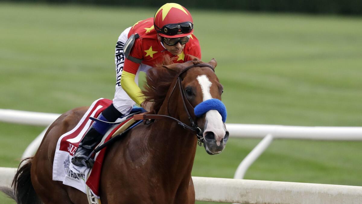 Jockey Mike Smith rides Justify into the far turn during the Belmont Stakes horse race on June 9, 2018, at Belmont Park in Elmont, N.Y.