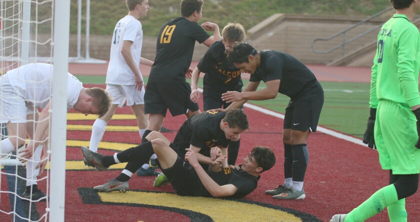 Senior Chris Tonelli (on ground) and teammates react after he scored Thursday's first goal.