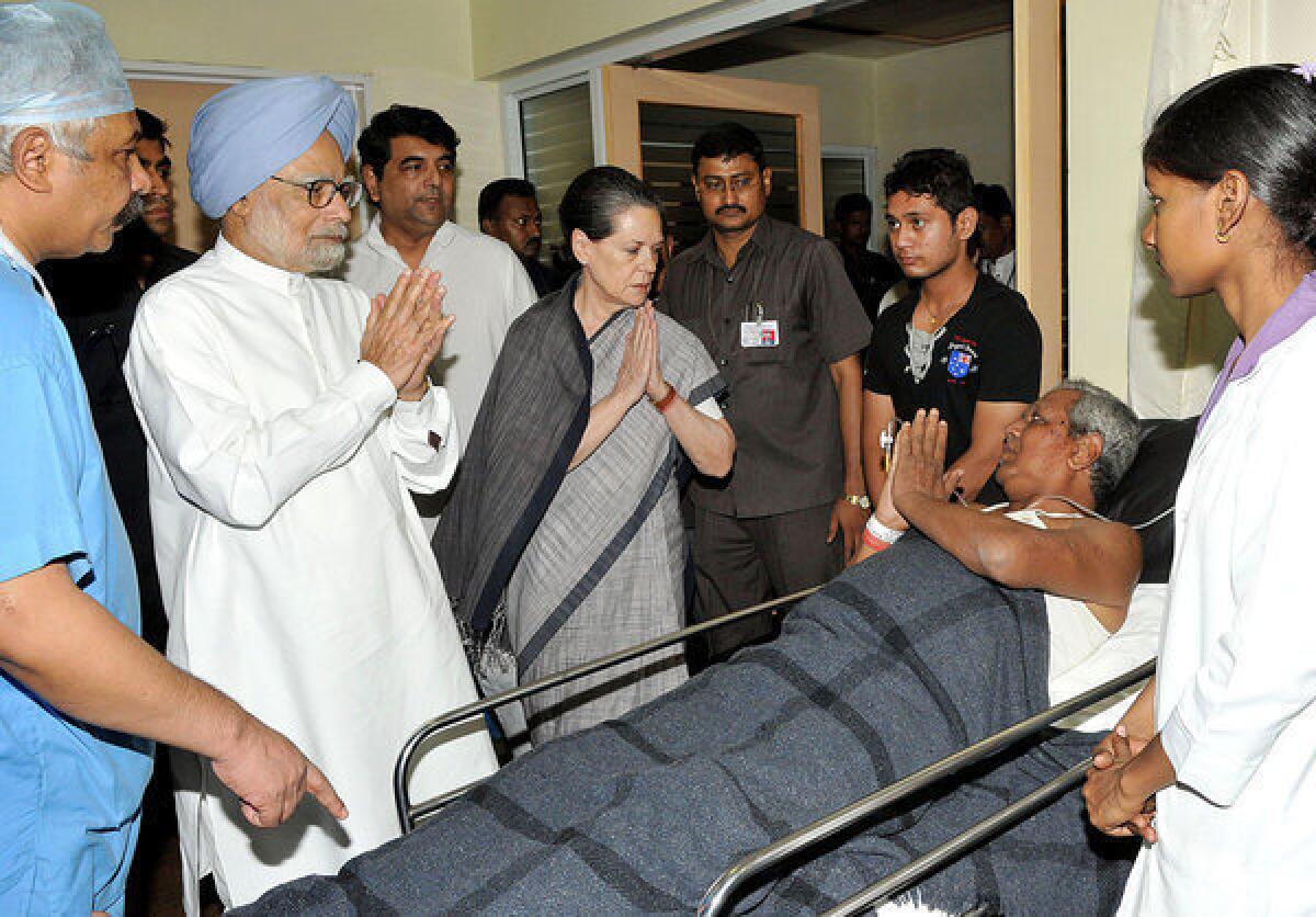 Indian Prime Minister Manmohan Singh, second from left, and chairperson of the National Advisory Council Sonia Gandhi, fourth from left, meet an injured person at the Rama Krishna Care Hospital in Raipur, the capital of central Chhattisgarh state. A heavily-armed gang of nearly 300 Maoist rebels killed at least 24 people in an attack on a convoy of local Congress Party leaders and supporters on Saturday, authorities said.
