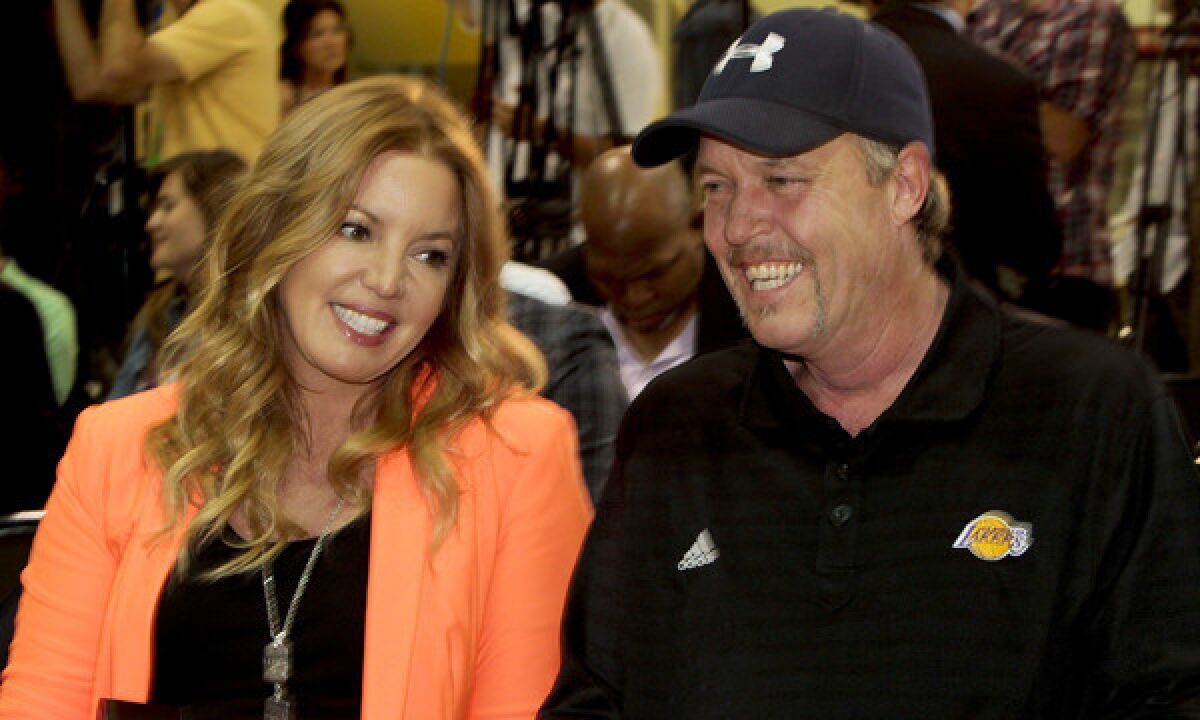 Jeanie and Jim Buss smile during a news conference in El Segundo announcing Dwight Howard as a member of the Lakers on Aug. 10, 2012.