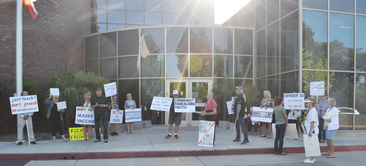 Protestors outside the Poway Unified School District office June 3 carried signs against critical race theory