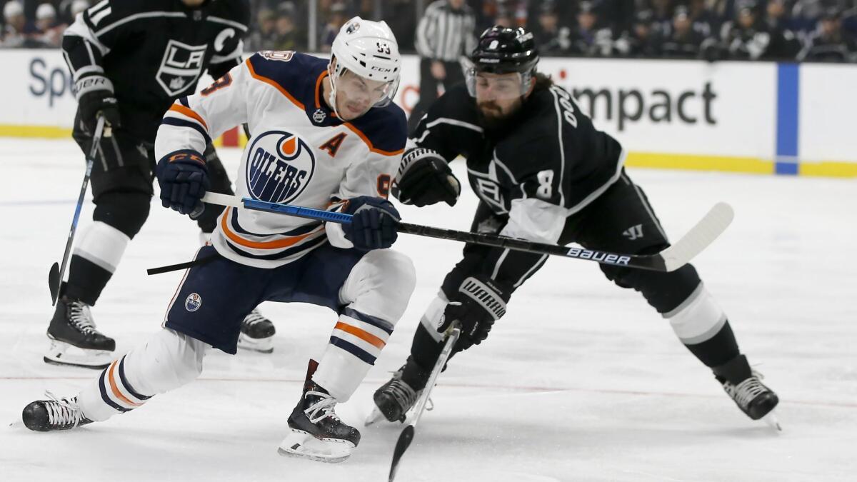 Edmonton Oilers center Ryan Nugent-Hopkins, center, shoots a backhander in front of Kings defenseman Drew Doughty during a game in November.