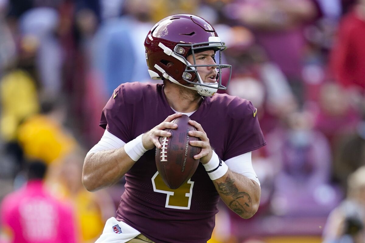 Washington Football Team quarterback Taylor Heinicke (4) looking downfield to pass the ball during the first half of an NFL football game, Sunday, Oct. 17, 2021, in Landover, Md. (AP Photo/Mark Tenally)