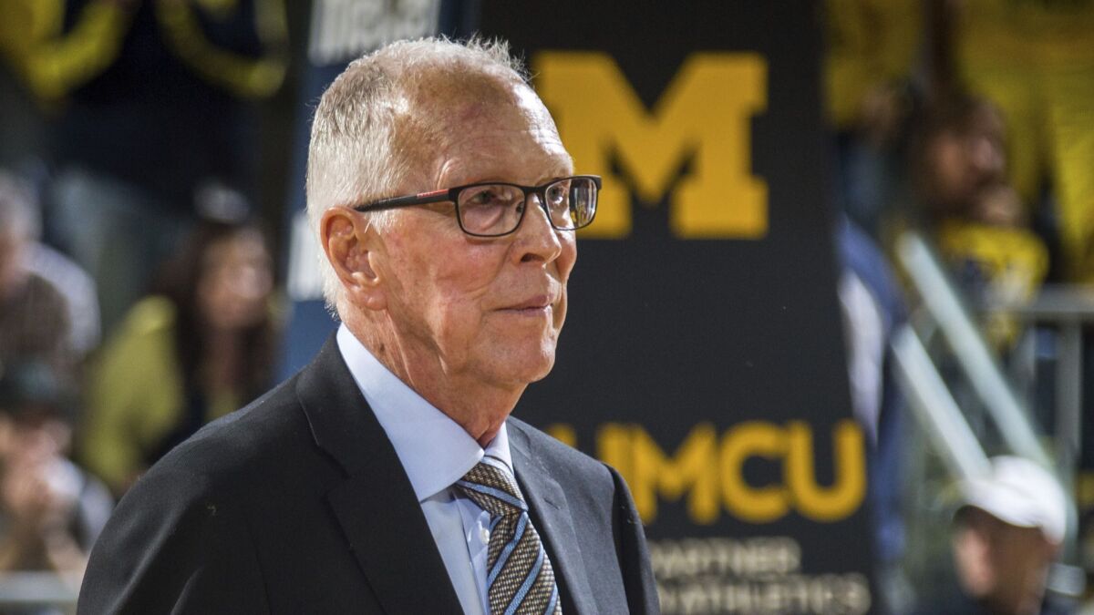 Former Michigan coach Steve Fisher joins his 1989 NCAA championship team on the court at halftime of the Wolverines' game against Michigan State at Crisler Center on Sunday.