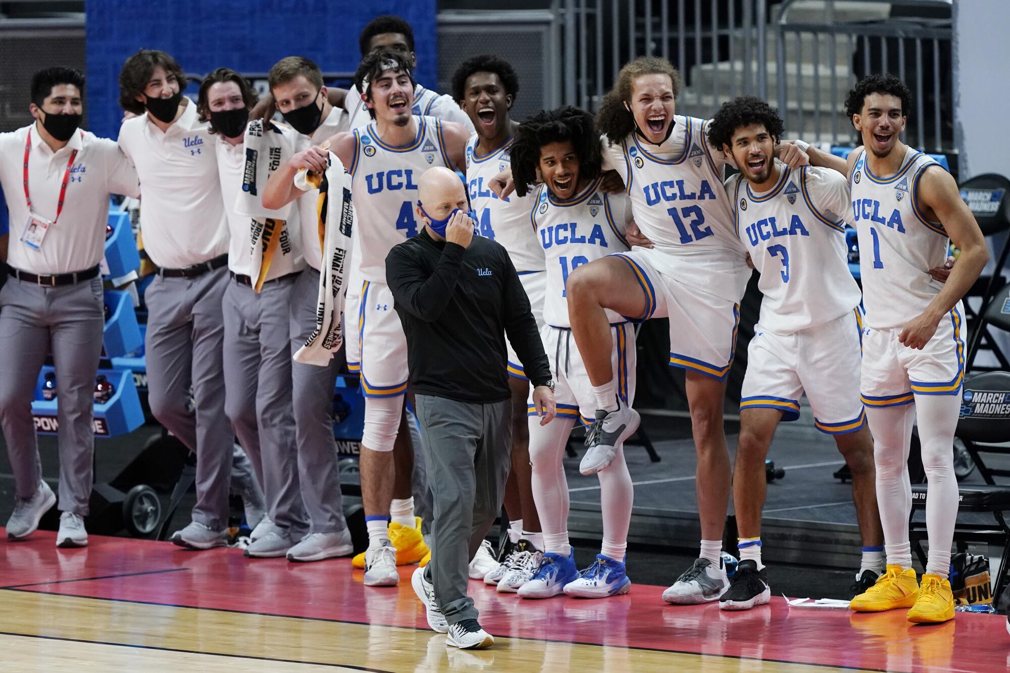 UCLA coach Mick Cronin and some of his players watch the final moments of the Bruins' win