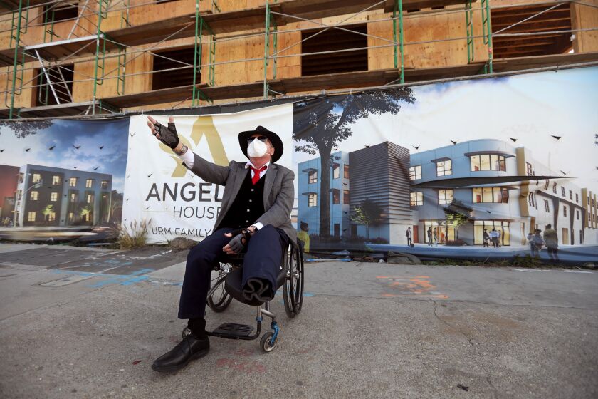 LOS ANGELES, CA - Rev. Andy Bales, CEO of the Union Rescue Mission (URM), attends a ceremony for, "Angeles House," a day after he had his second leg amputated in South Los Angeles on February 25, 2021. "I lost my leg yesterday. Other than that I'm all right," said Rev. Bales at the site that will offer 86 family apartments to the homeless. His surviving leg had ongoing problems and he suffered a broken foot that contributed to his loss. "The two days before I had it cut off were the most painful so I knew I had to have it removed," he said. The 72,000 square foot facility, along S. Avalon Blvd., was funded by private individuals, foundations and corporations. It's due to be completed by November or December of this year. (Genaro Molina / Los Angeles Times)