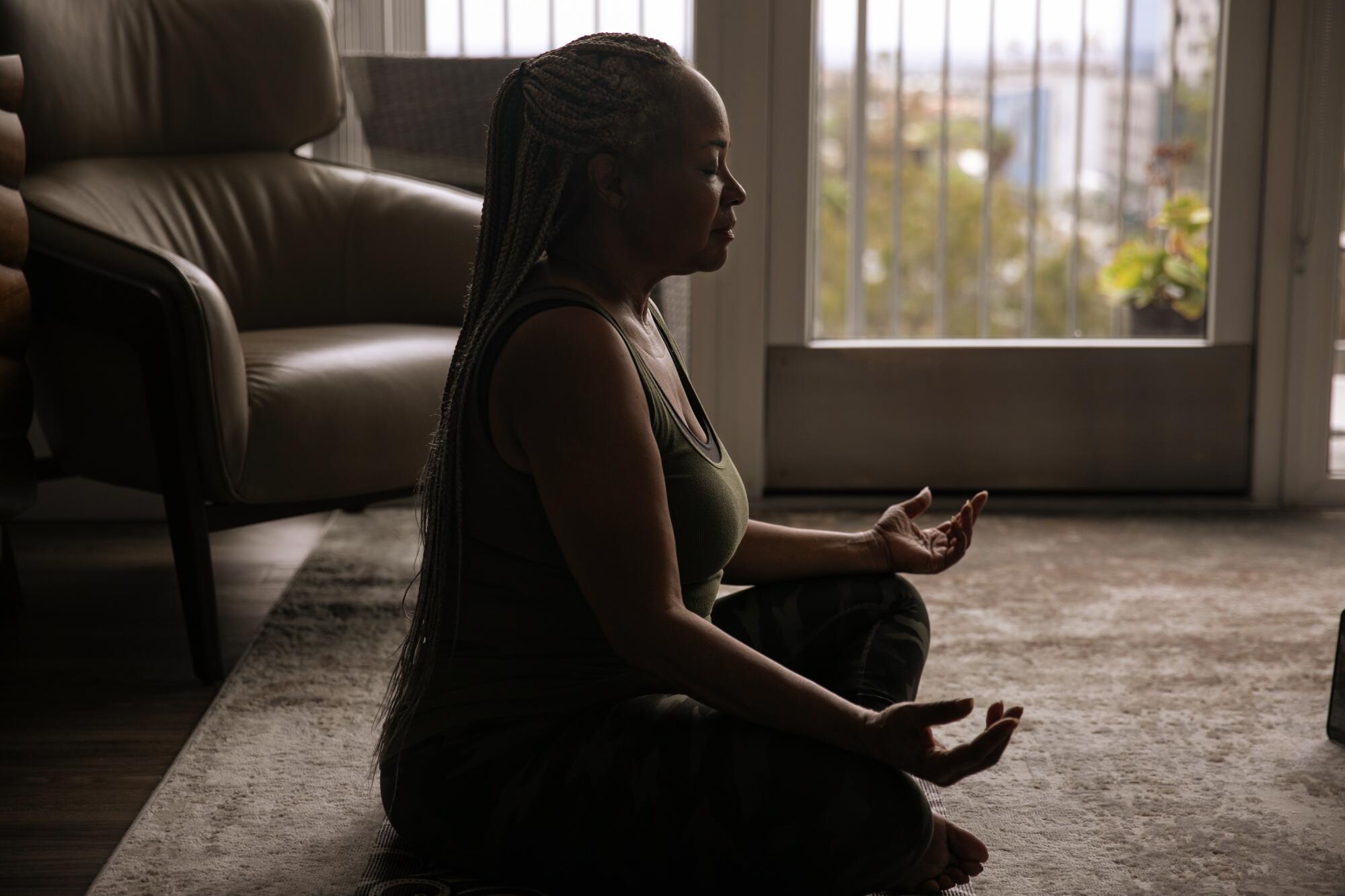 Deneen Vaughn participates in a virtual yoga session that her family's Mindfulness and Wellness Foundation