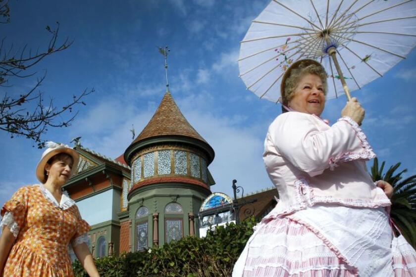 Dressed in 1880s attire, women attend the re-opening of Villa Montezuma house museum.