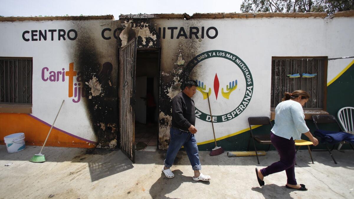 Migrants at Caritas Tijuana, a small Catholic-run shelter, awoke to a burning mattress put outside their door early Monday.