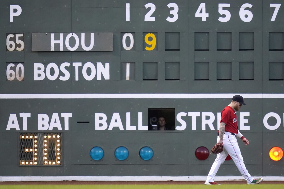 Boston Red Sox left fielder Alex Verdugo walks back to his position during the second inning of the team's baseball game against the Houston Astros at Fenway Park, Tuesday, May 17, 2022, in Boston. (AP Photo/Charles Krupa)