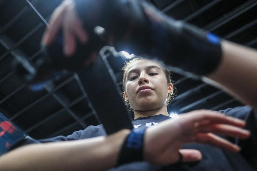South Gate, CA - November 07: Perla Bazaldua is an 18-year old boxer who recently won an international tournament in Germany wraps her hands for training at Magnifico Boxing on Tuesday, Nov. 7, 2023 in South Gate, CA. (Ringo Chiu / For Los Angeles Times en Espanol)