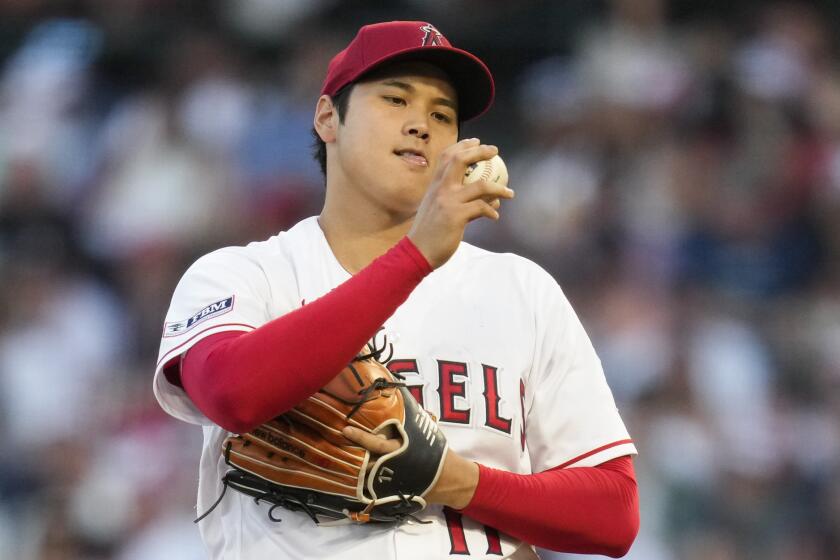 Los Angeles Angels starting pitcher Shohei Ohtani (17) looks at a ball during the fourth inning.