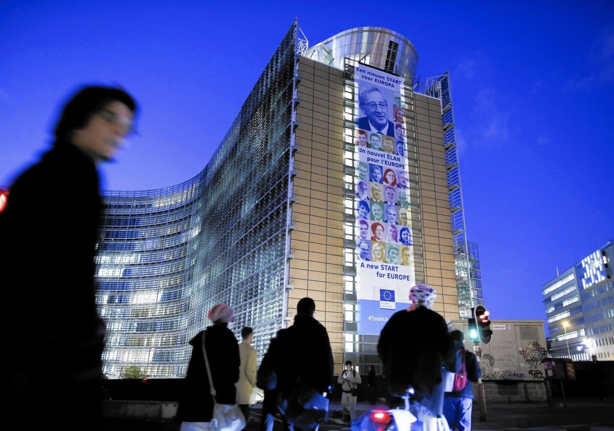 A giant placard with the portraits of the EU commissioners is attached to a facade of the EU Commission headquarters in Brussels.