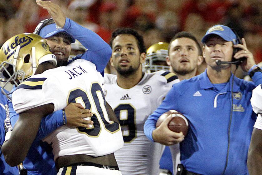 UCLA defensive coordinator Jeff Ulbrich congratulates linebacker Myles Jack after he recovered a fumble during a 2013 victory over Arizona.