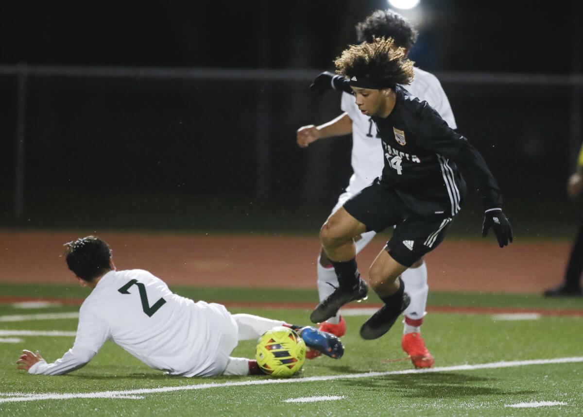 Estancia's Brandon Garcia (14) makes a move on Costa Mesa's Roman Serpas (2) for a shot on goal on Wednesday.