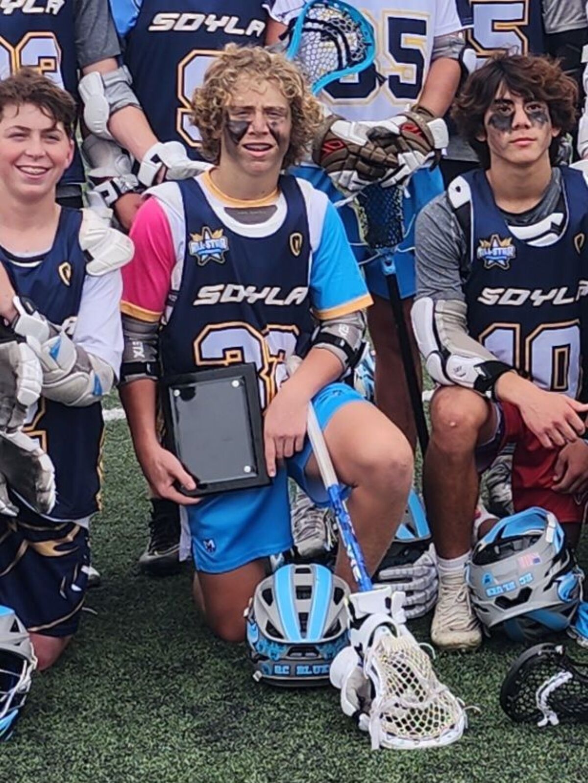 Harrison Jacobsen (center), the 2023 Player of the Year selected by San Diego Youth Lacrosse Association.