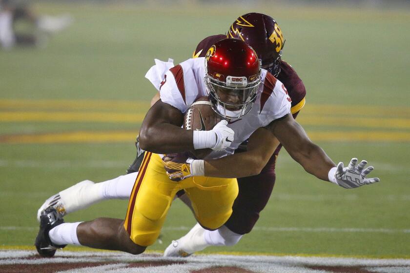 USC's JuJu Smith-Schuster dives forward as Arizona State's Jordan Simone arrives to make the tackle during a Sept. 26 game in Tempe, Ariz.