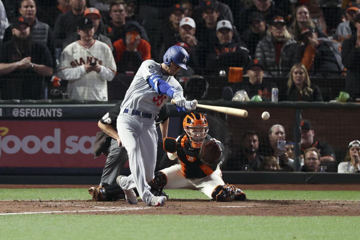 Cody Bellinger hits a run-scoring single for the Dodgers in the ninth inning of Game 5.