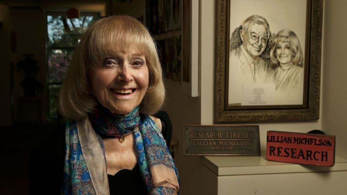 Lillian Michelson next to an artist's rendering of her and late husband Harold Michelson at her home in Woodland Hills.