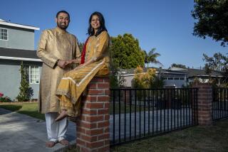Adil Sheikh, 38, and his wife Safia Sheikh, 39, are photographed in front of their home in Los Angeles.