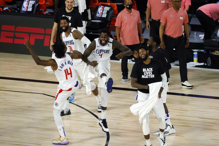 Members of the Los Angeles Clippers celebrate after breaking a team three-point record during an NBA basketball game against the New Orleans Pelicans, Saturday, Aug. 1, 2020, in Lake Buena Vista, Fla. (Kevin C. Cox/Pool Photo via AP)