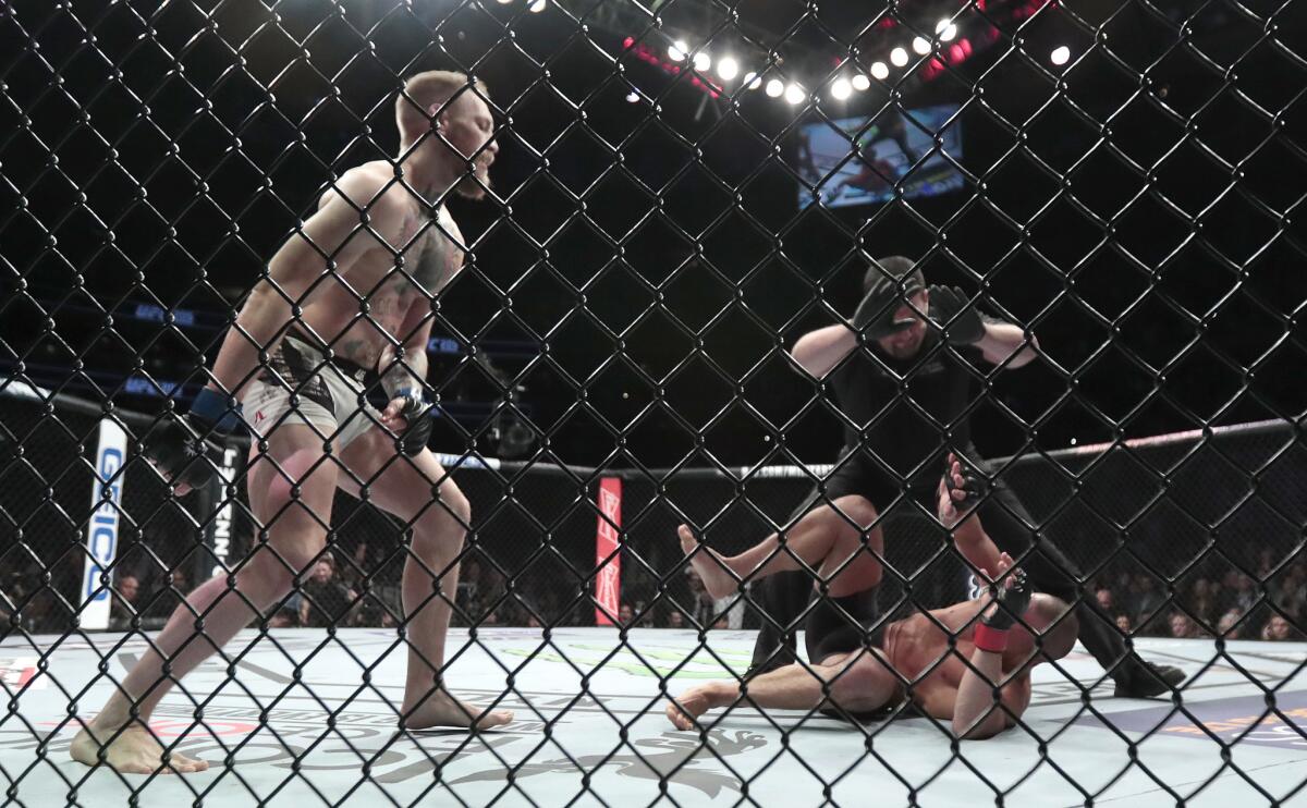 Conor McGregor reacts knocking out Eddie Alvarez in the second round of the lightweight title fight at UFC 205.