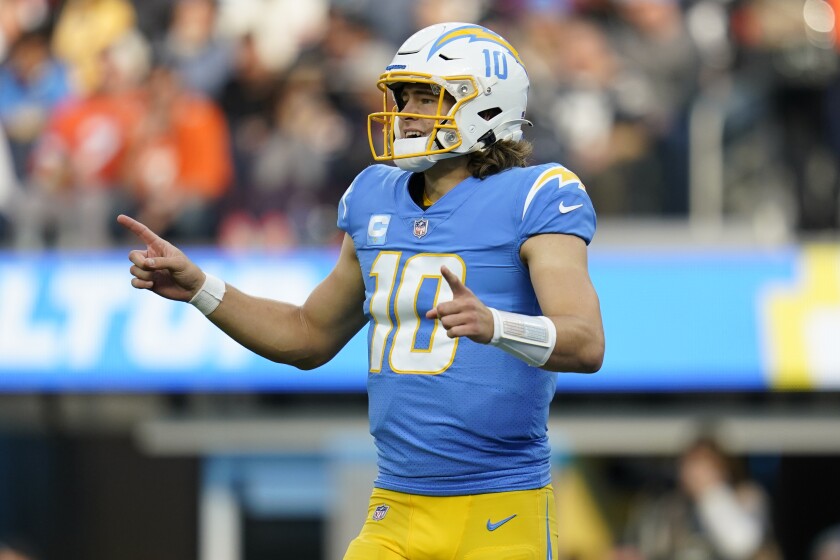 Los Angeles Chargers quarterback Justin Herbert (10) signals during the first half of an NFL football game against the Denver Broncos Sunday, Jan. 2, 2022, in Inglewood, Calif. (AP Photo/Ashley Landis)