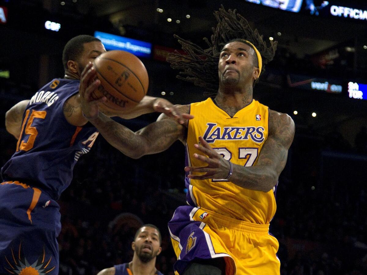 Lakers center Jordan Hill, right, puts up a shot past Phoenix forward Marcus Morris during the Lakers' loss to the Suns on Dec. 10.