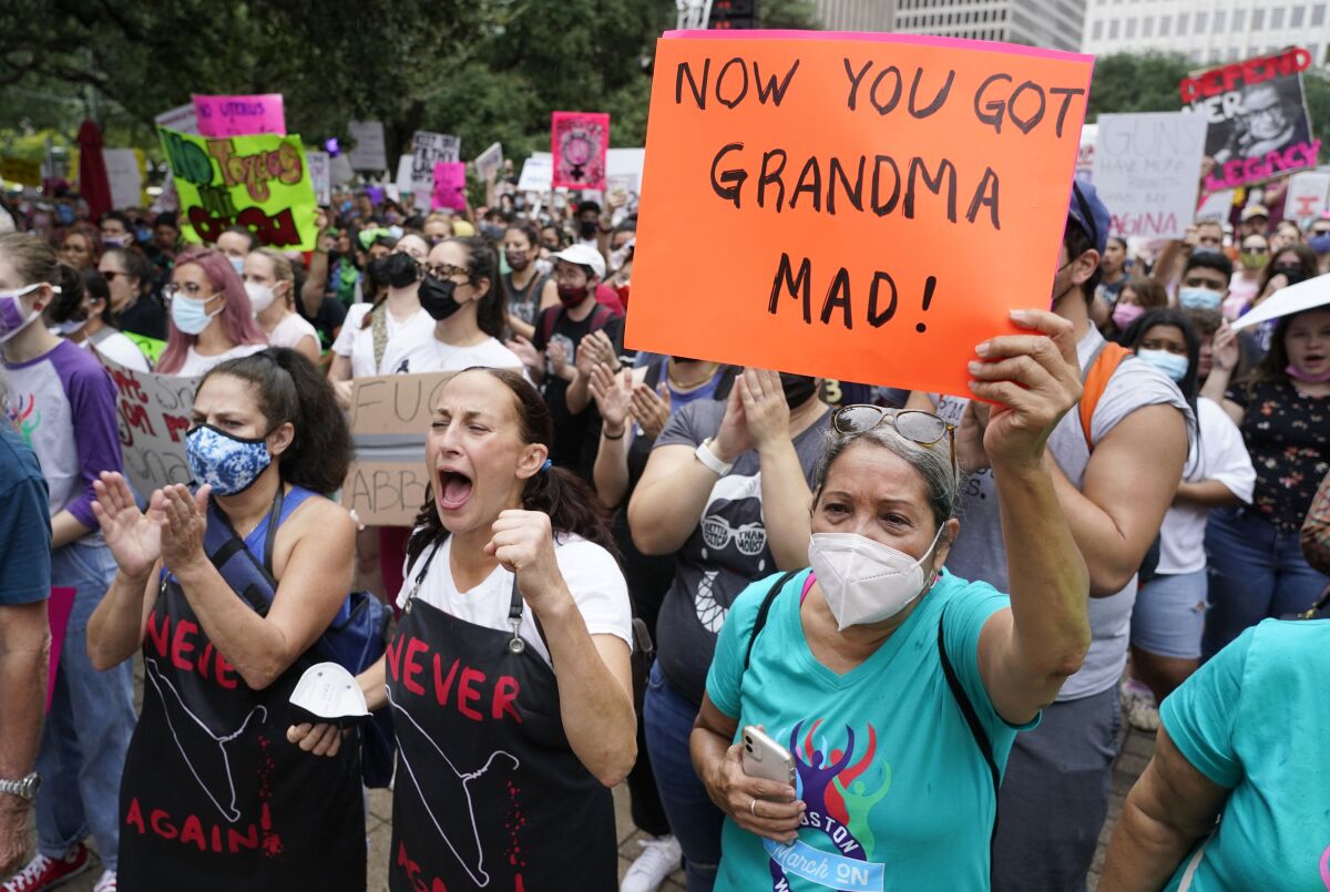 People participating in the Houston Women's March against Texas abortion ban listen to speakers at City Hall Saturday, Oct. 2, 2021, in Houston. (Melissa Phillip/Houston Chronicle via AP)