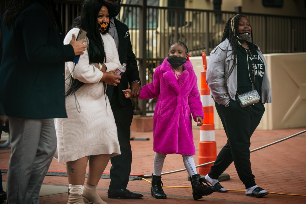 Gianna Floyd, the daughter of George Floyd, walks towards the entrance of the the courthouse with her family. 