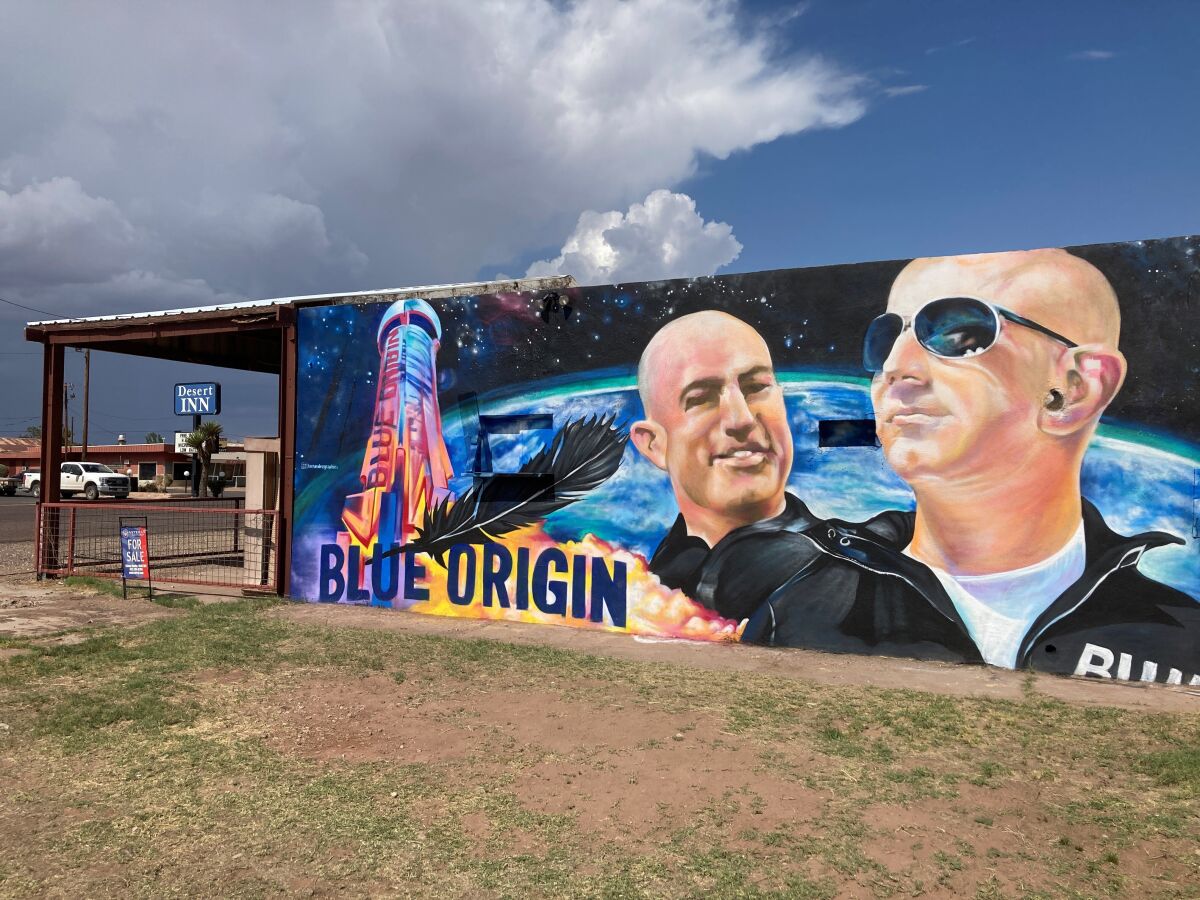 The side of a building in Van Horn, Texas, is adorned with a mural of Blue Origin founder Jeff Bezos on Saturday, July 17, 2021, just days before Bezos plans to launch into space from the Blue Origin spaceport about 25 miles outside of the West Texas town. (AP Photo/Sean Murphy)
