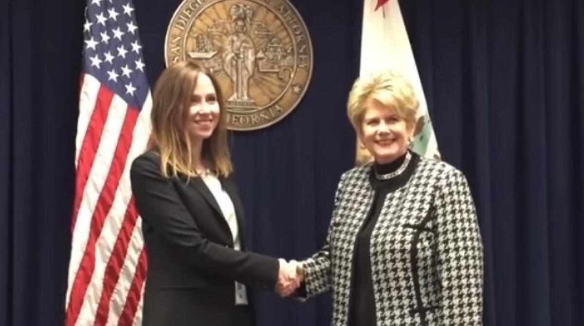 District Attorney Bonnie Dumanis congratulates new prosecutor Miriam Milstein, left, at a swearing-in ceremony captured by the county's promotional videographers in January.