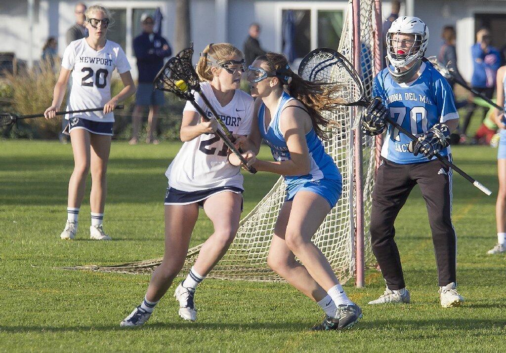 Newport Harbor High's Heather Roberts, left, and Corona del Mar's Simone Oberreiter go head-to-head during the Battle of the Bay.