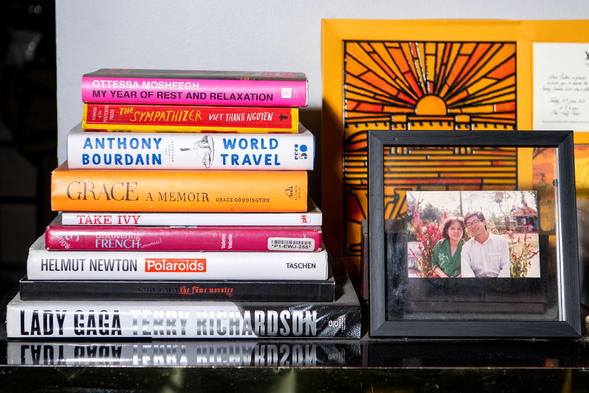 A stack of books and a framed family picture at stylist Bin X. Nguyen's home.