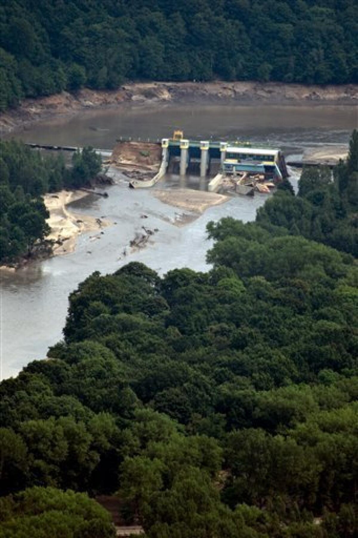 Aerial view shows the broken wall of the Witka dam near Radomierzyce, Poland near the German boder Sunday Aug. 8, 2010. The death toll in flooding in central Europe rose more than 10 as Poland's interior minister said Sunday that two more people had died in the southwestern region of the country. The flooding has struck an area near the borders of Poland, Germany and the Czech Republic. (AP Photo/ddp/ Jens Schlueter/ddp)